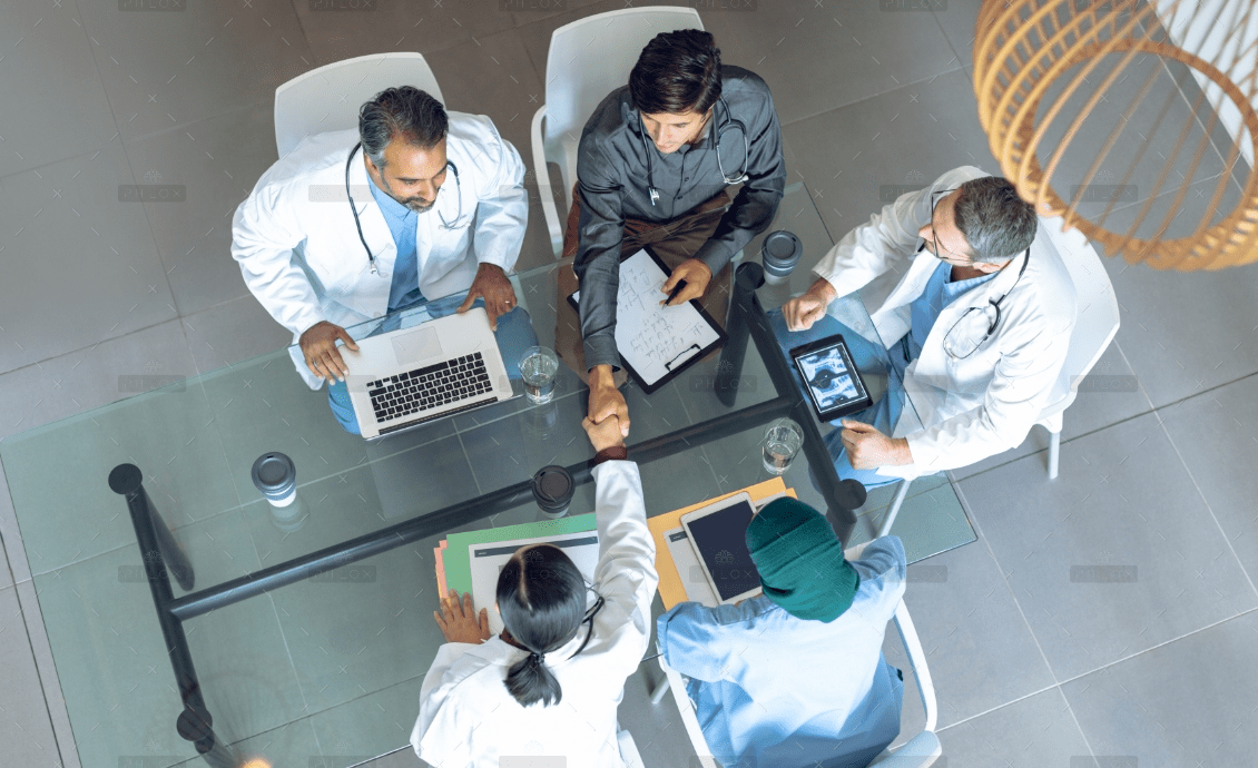 diverse medical team working together at table in 8CASYHB